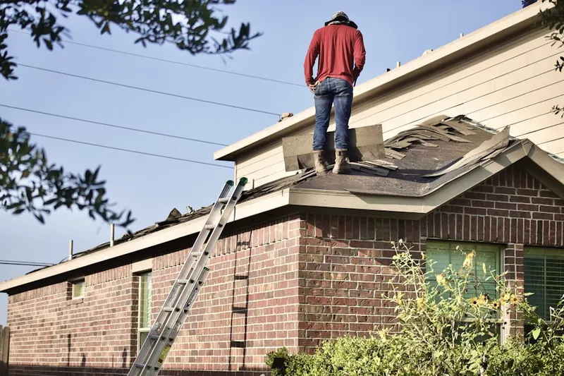Professional roofer working on a residential roof in South Floral Park